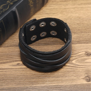 Macro detail of multi-layer leather bracelet with adjustable silver metal snap fasteners