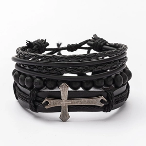 Detail of multi-layer black leather bracelets with matte wood beads and engraved cross