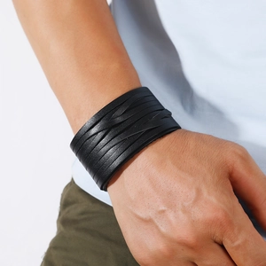 Men's wide multi-layer black woven leather wrap bracelet in punk style on model's wrist