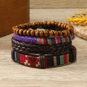 Bohemian style 4-piece bracelet set with wooden beads and woven leather on wood
