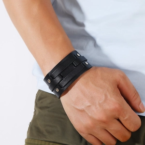 Punk style wide black leather bracelet for men featuring silver metal rivets and layered design