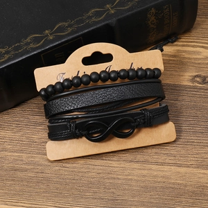 Detail of four-piece black punk style men's braided leather and beaded infinity bracelet set
