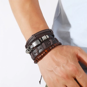 Macro detail of men's vintage multi-layer leather bracelet with wooden beads and metal clasp