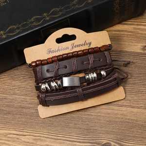 Detail of four-piece vintage men's leather bracelet set with wooden beads and braided texture