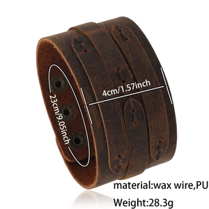 Detail view of vintage wide leather bracelet with hand-stitched wax wire and snap button