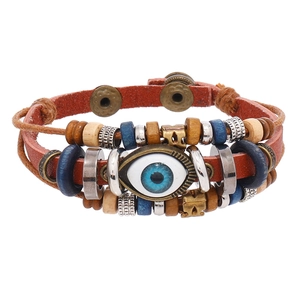 Detail of multi-layer leather bracelet with evil eye charm and vintage beads