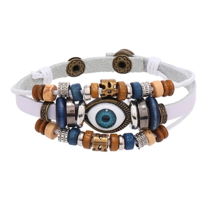 Detail of multi-layer leather bracelet with evil eye charm and snap button closure