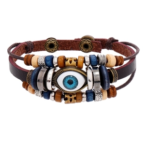 Multilayer leather bracelet with blue evil eye bead and vintage ethnic charms