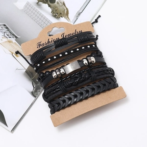 Detailed macro view of 5-piece black braided leather bracelet set with studs and beads