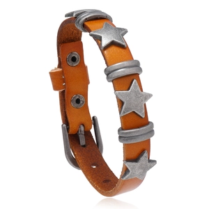 Detail of vintage leather bracelet showing star rivets and needle buckle closure