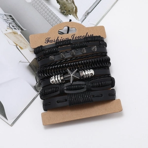Macro shot of multilayer black faux leather braided bracelets with metal star and studs
