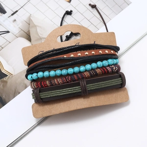 Detail of layered turquoise beaded bracelets and woven leather bands on display card