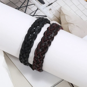 Detail of hand-woven leather bracelets in black and brown with textured braiding