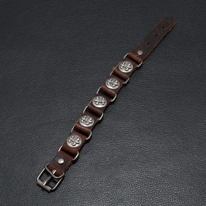 Vintage brown leather wristband with silver fleur-de-lis metal studs and buckle closure