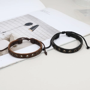 Adjustable two-piece woven leather bracelet set in black and brown with metal rivets