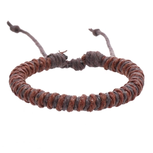 Detail of adjustable spiral braided wax rope bracelet with ethnic retro brown weaving