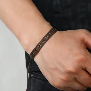 Men's vintage brown braided leather bracelet with bronze eyelets and adjustable cord