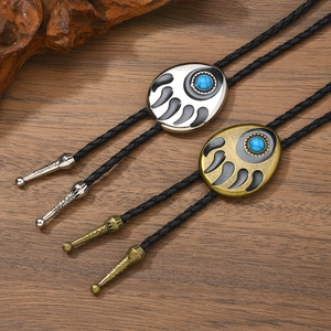 Silver and bronze Bolo ties featuring Indian bear paw design with turquoise inlays