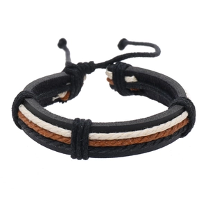 Detail view of multilayer woven leather bracelet with adjustable cords in black and brown