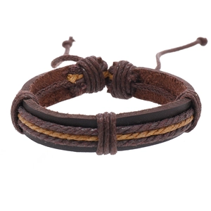 Detail of multi-layer vintage leather bracelet with dark brown and ginger braided cords