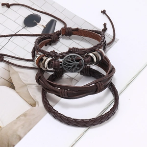 Detailed view of multilayer leather bracelet with a retro tree of life metal charm
