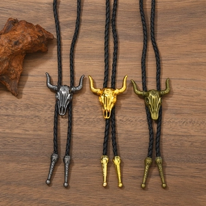 Western bolo ties with bull skull pendants in silver, gold, and bronze on braided cords