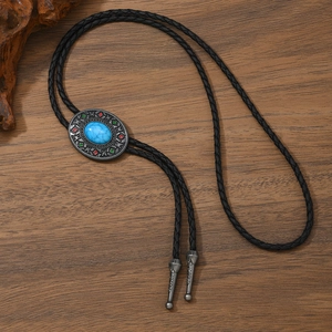 Detail of vintage bolo tie with turquoise stone, silver metal slide and black leather cord