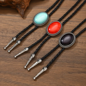 Vintage western bolo tie set with turquoise red and purple stones on woven leather cord