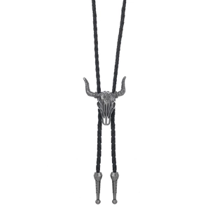 Detail of vintage bull head bolo tie with silver engraved metal slide and black cord