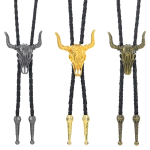 Three western style bolo ties featuring bull skull pendants in silver, gold and bronze finishes