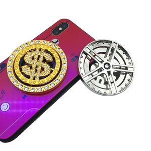 Detail of rotating dollar sign and car wheel phone grip with rhinestones on purple case