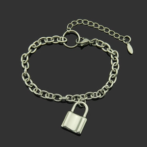 Close-up of silver Cuban link chain bracelet with a smooth padlock pendant and lobster clasp