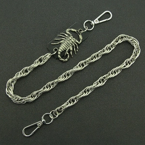 Detail of punk silver metal wallet chain featuring a scorpion pendant and lobster clasps