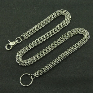 Detailed view of silver punk pants chain with braided links and lobster clasp connectors