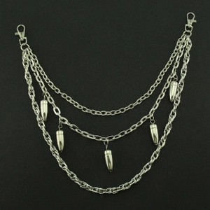 Detail of hip hop pants chain with silver metal layers and hanging bullet pendants