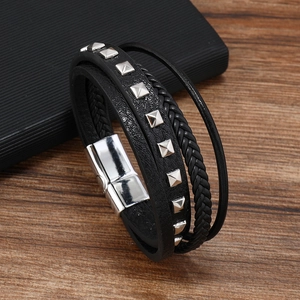 Close-up of multi-layer black leather bracelet with silver studs and magnetic buckle