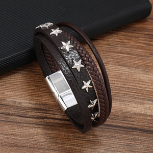 Detail of dark brown leather multi-layer bracelet with silver star rivets and magnetic clasp