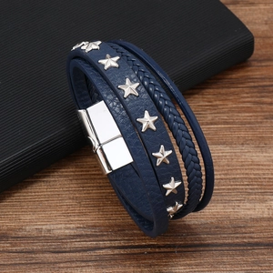Macro shot of navy blue multi-layer leather bracelet with silver star studs and magnetic clasp
