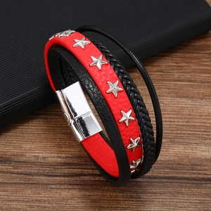 Detail of multi-layer leather bracelet featuring silver stars and magnetic metal clasp