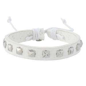 Macro shot of white leather punk bracelet featuring square silver metal pyramid studs