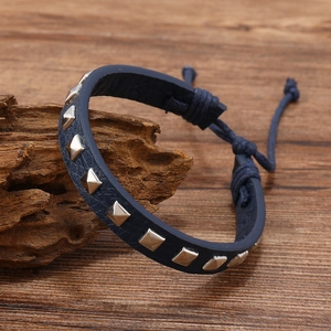 Detailed shot of navy leather bracelet with silver square studs and adjustable cord