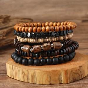 Close-up of vintage multi-layer wooden bead bracelets set for men on a natural wood stand