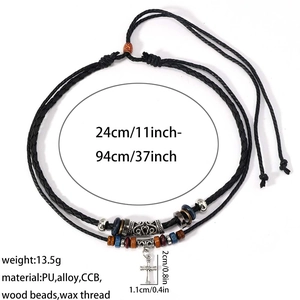 Detail of vintage silver alloy cross pendant with multi-layer braided black beaded wax cord