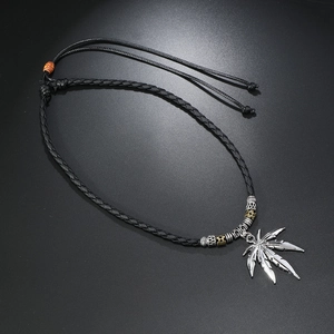 Detail of adjustable woven leather necklace with silver leaf pendant and metal beads