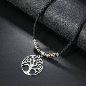 Detail of tree of life pendant with vintage beads on adjustable black cord necklace