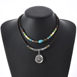 Detail of retro beaded necklace with heart pendant and brown braided leather cord