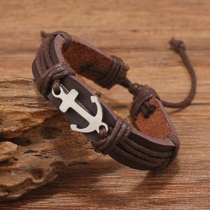 Detail view of leather multi-layer bracelet with silver anchor and braided cord