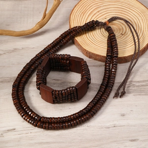 Detail of handmade men's dark wood bead jewelry set with necklace and layered bracelet