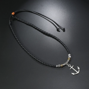 Macro view of adjustable braided cord necklace with vintage silver anchor pendant