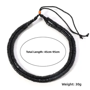 Detail of black beaded necklace with adjustable braided rope closure, total length 45cm to 95cm